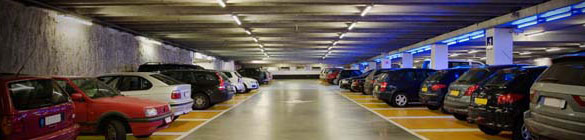 Cars parked in a brightly lit garage.