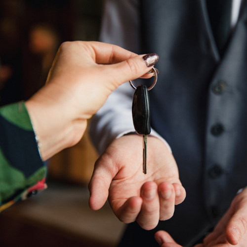 Hand holding a car key.